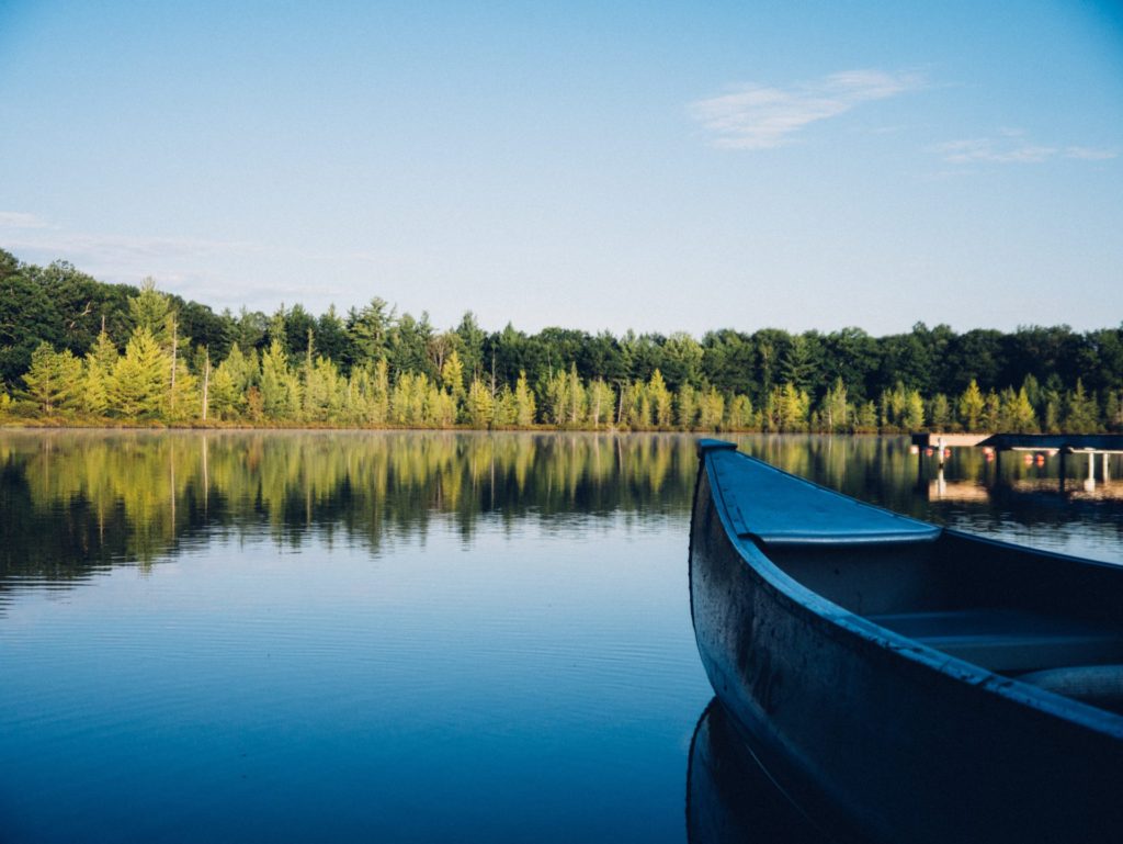 Do you like to enjoy the nature? Here on the image, a boat on the water. Then you know why some wonder about does burning coffee repel mosquitoes?