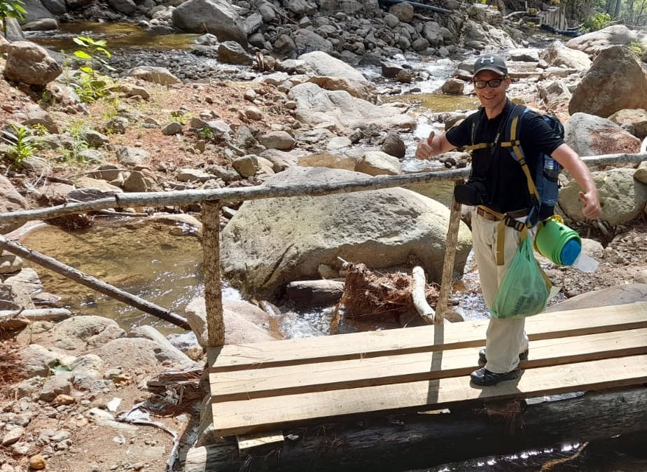 Here I am out hiking, crossing a small river. With full backpack. But the coffee is always with me. Learn more about cordless coffee makers in the article.