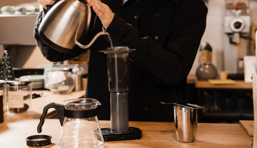 A man using an Aeropress to brew his coffee. Learn more about that in this article.