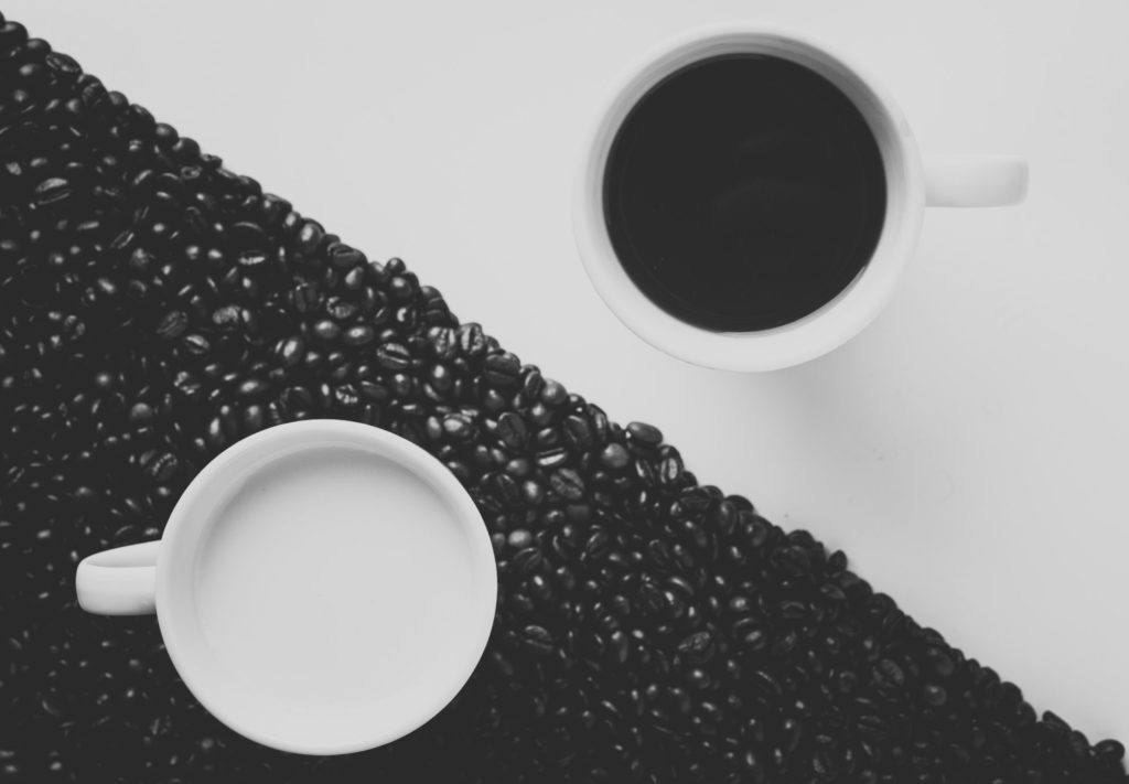 Future of Coffee 2.0 post, showing two coffee cups on a background divided into two parts. Black and white, and the black part is made with coffee beans